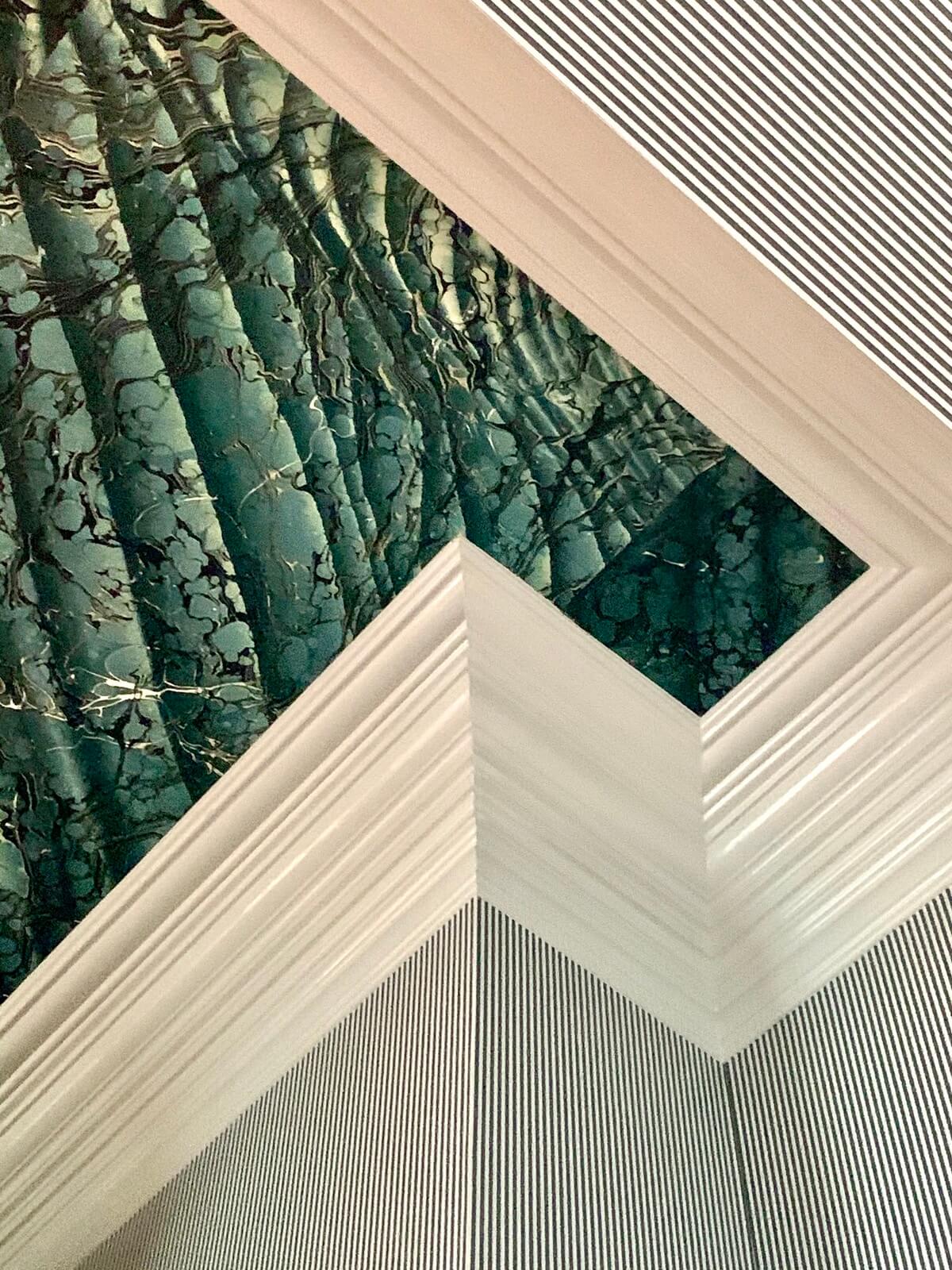 Green wallcovering where molding meets at ceiling